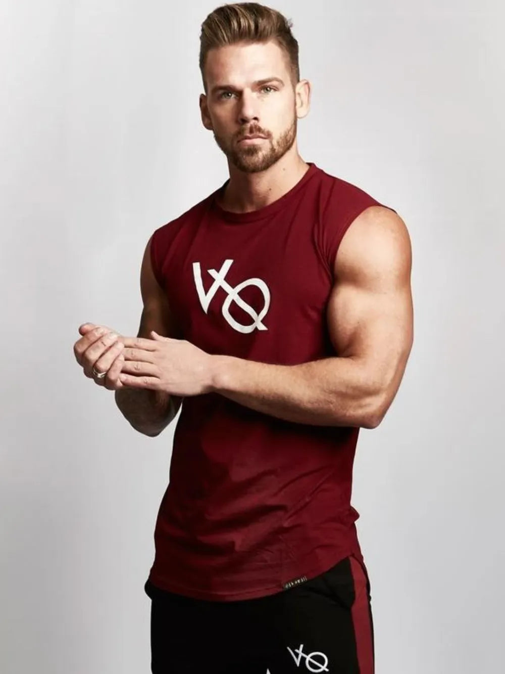 Burgundy graphic muscle tank top with white logo, sleeveless, crew neck.