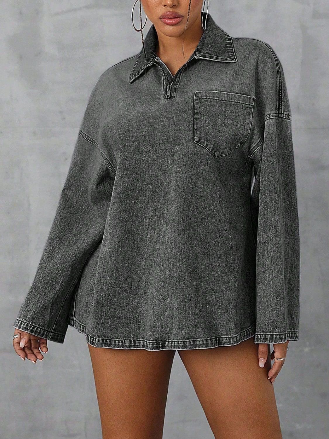 Oversized dark denim polo shirt with a quarter zip and chest pocket.