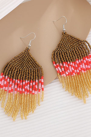 Geometric fringe beaded earrings in gold, red, and pink with dangling strands.