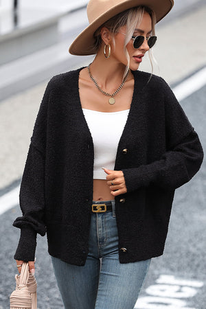 Black textured bouclé button-down cardigan with gold buttons, relaxed fit, and v-neck.