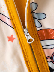 Baby one-piece with playful holiday print and yellow zipper detail.