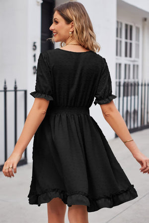 Black textured dot puff sleeve fit-and-flare dress with smocked waist and ruffled hem.