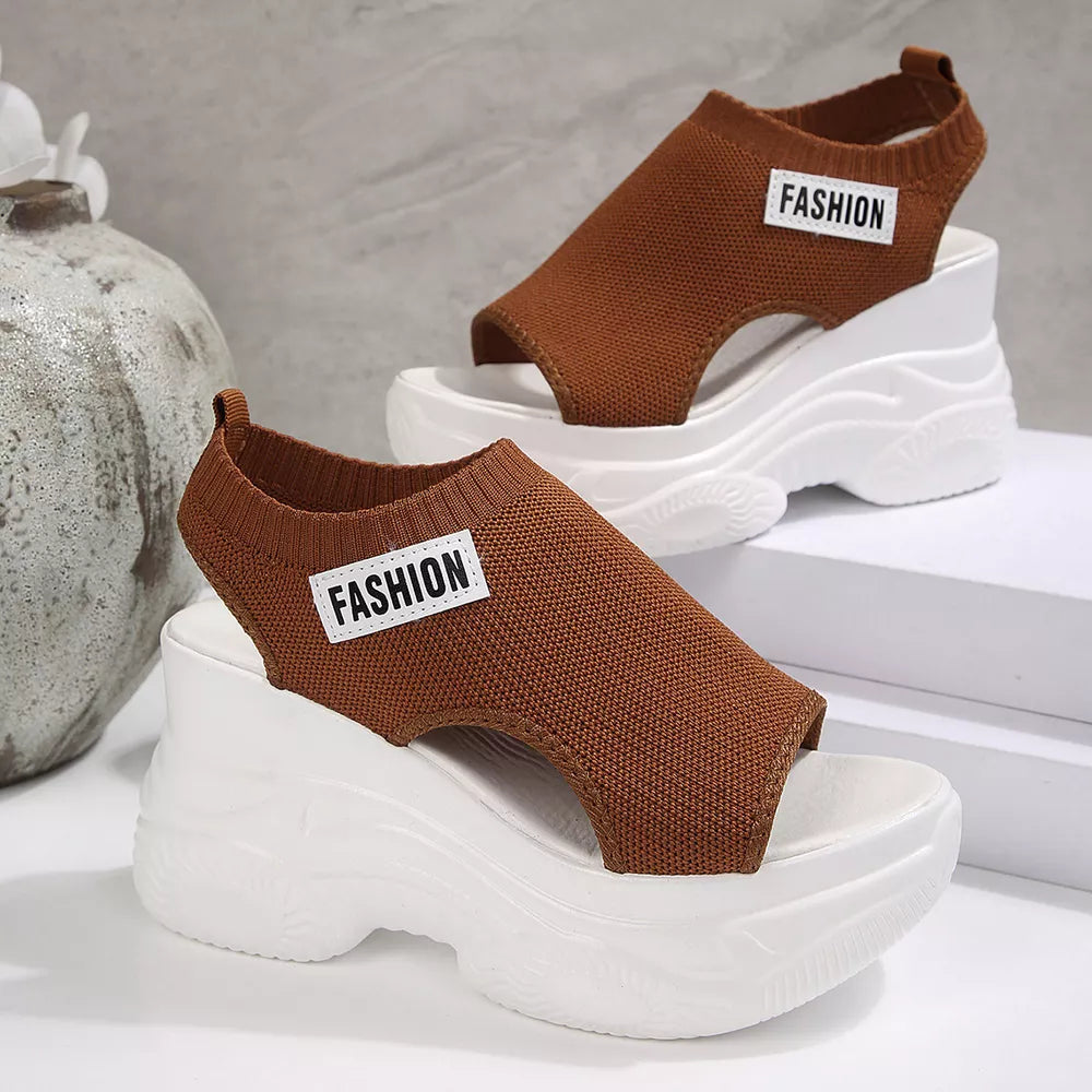 Brown knit open-toe wedge sandals with white chunky soles and "Fashion" detail.