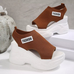Brown knit open-toe wedge sandals with white chunky soles and "Fashion" detail.