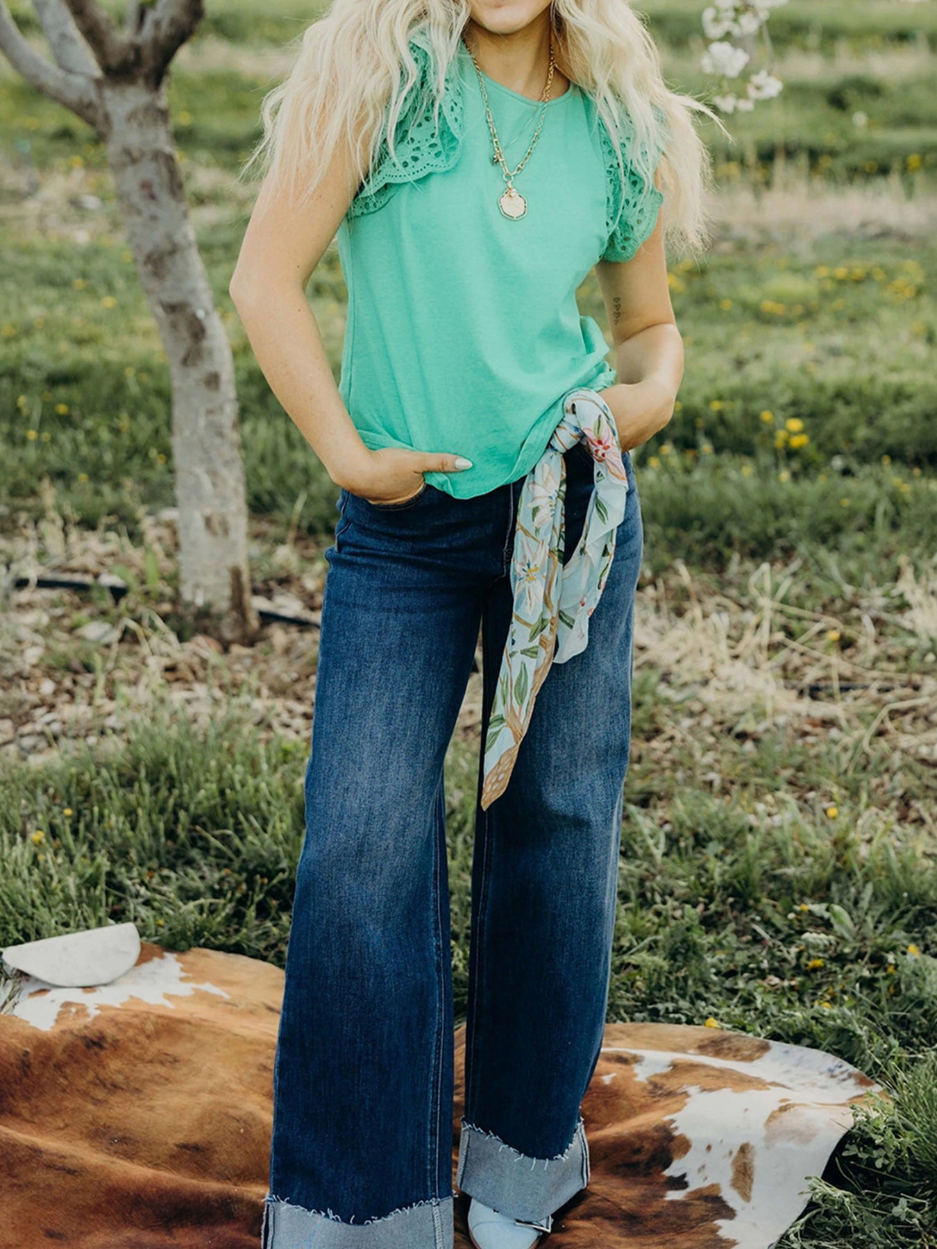 Green eyelet lace cap sleeve top with ruffled detail.