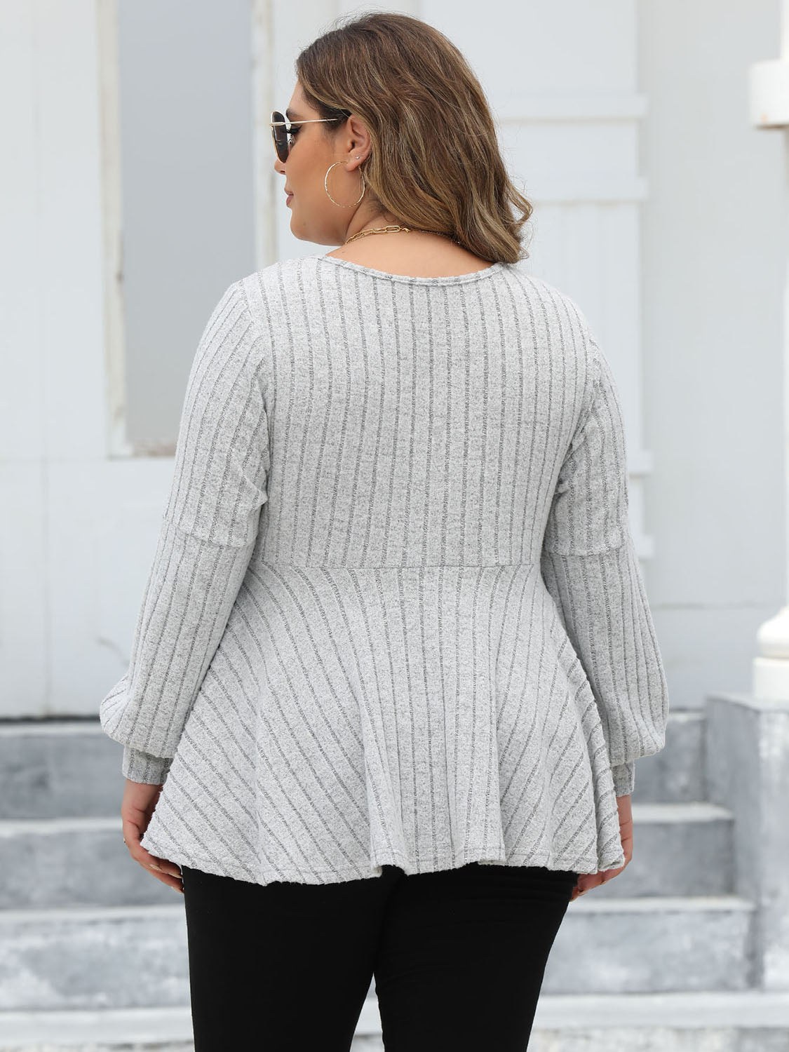 Light Gray ribbed peplum blouse with blouson sleeves and vertical stripes.