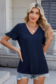 Dark navy textured v-neck blouse with ruffle short sleeves and pintuck detail