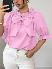 Pink ruffled bow sleeve blouse with cinched neckline and puff sleeves.