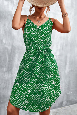 Green daisy print slip dress with tie waist and V-neck
