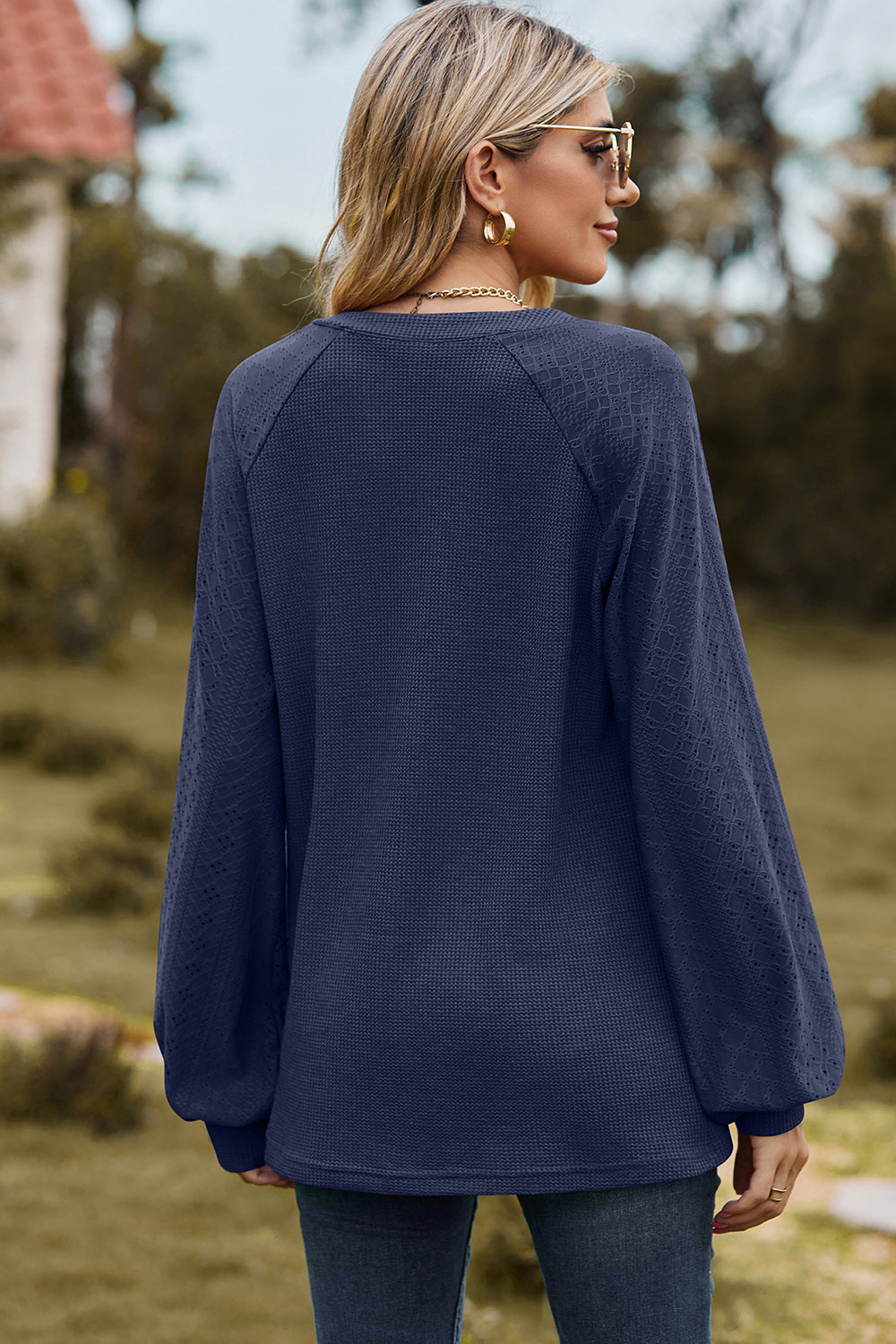 Dark Blue waffle knit raglan v-neck top with textured sleeves.