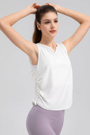 White active tank top with notched neckline and side ruching detail.