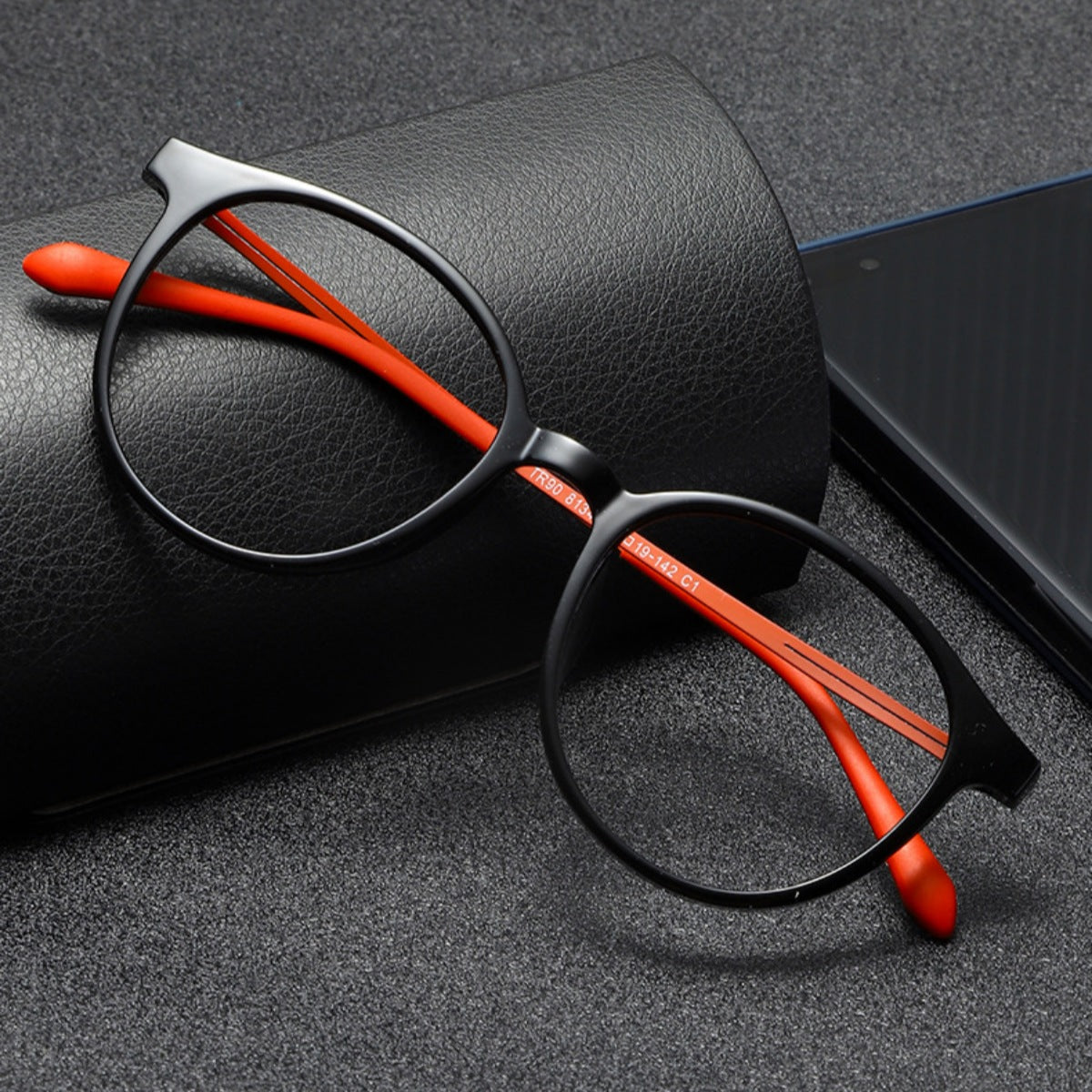 Black acetate round frame glasses with orange temples