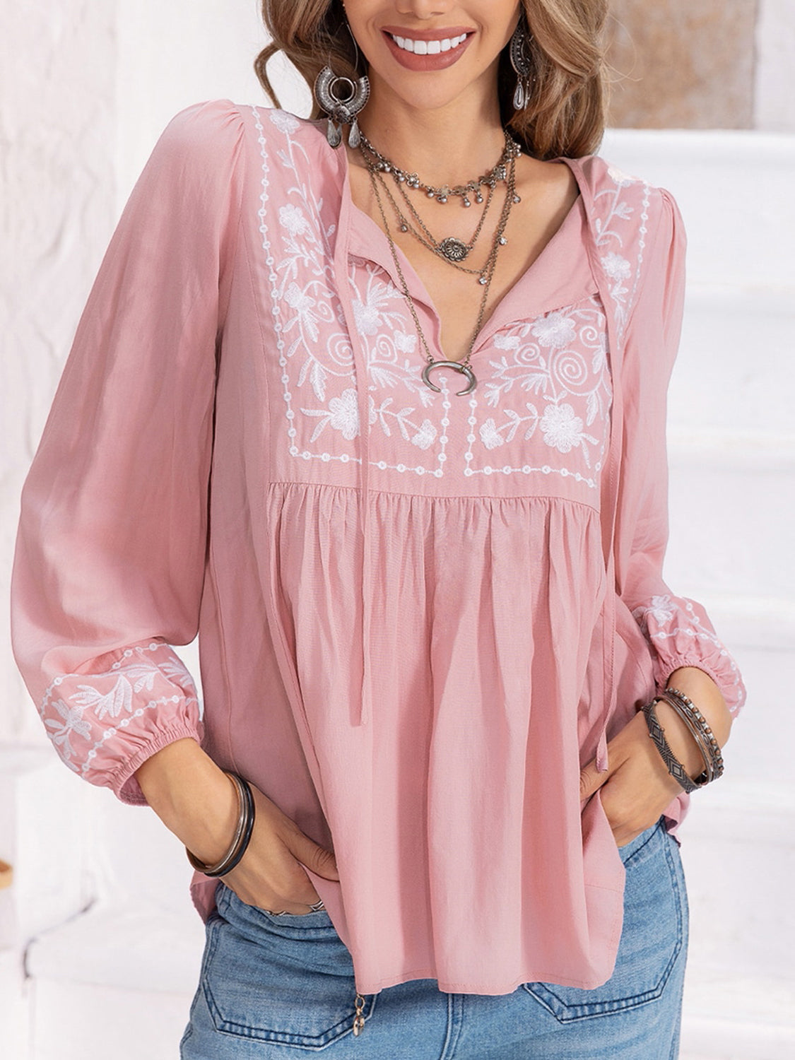 Blush pink embroidered yoke blouse with gathered bodice and tie neck