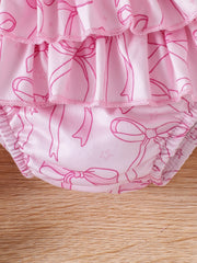 Pink baby bodysuit with bowknot print and ruffled tiers.