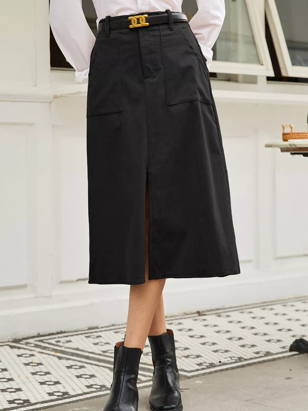 Black high-waisted midi skirt with buttoned pockets and front slit