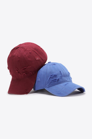 Deep red and cobalt blue distressed baseball caps with adjustable strap.