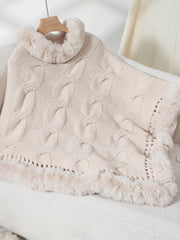 Eggshell cable knit poncho with faux fur trim and turtleneck detail.
