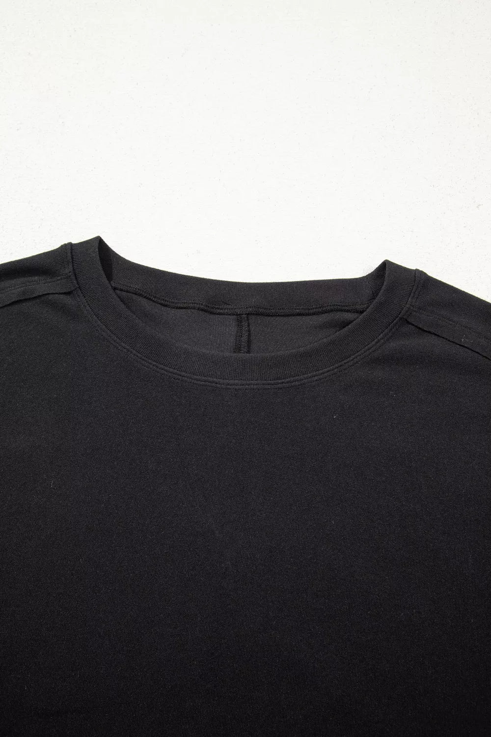 Black maternity t-shirt with crew neck and lace detail.