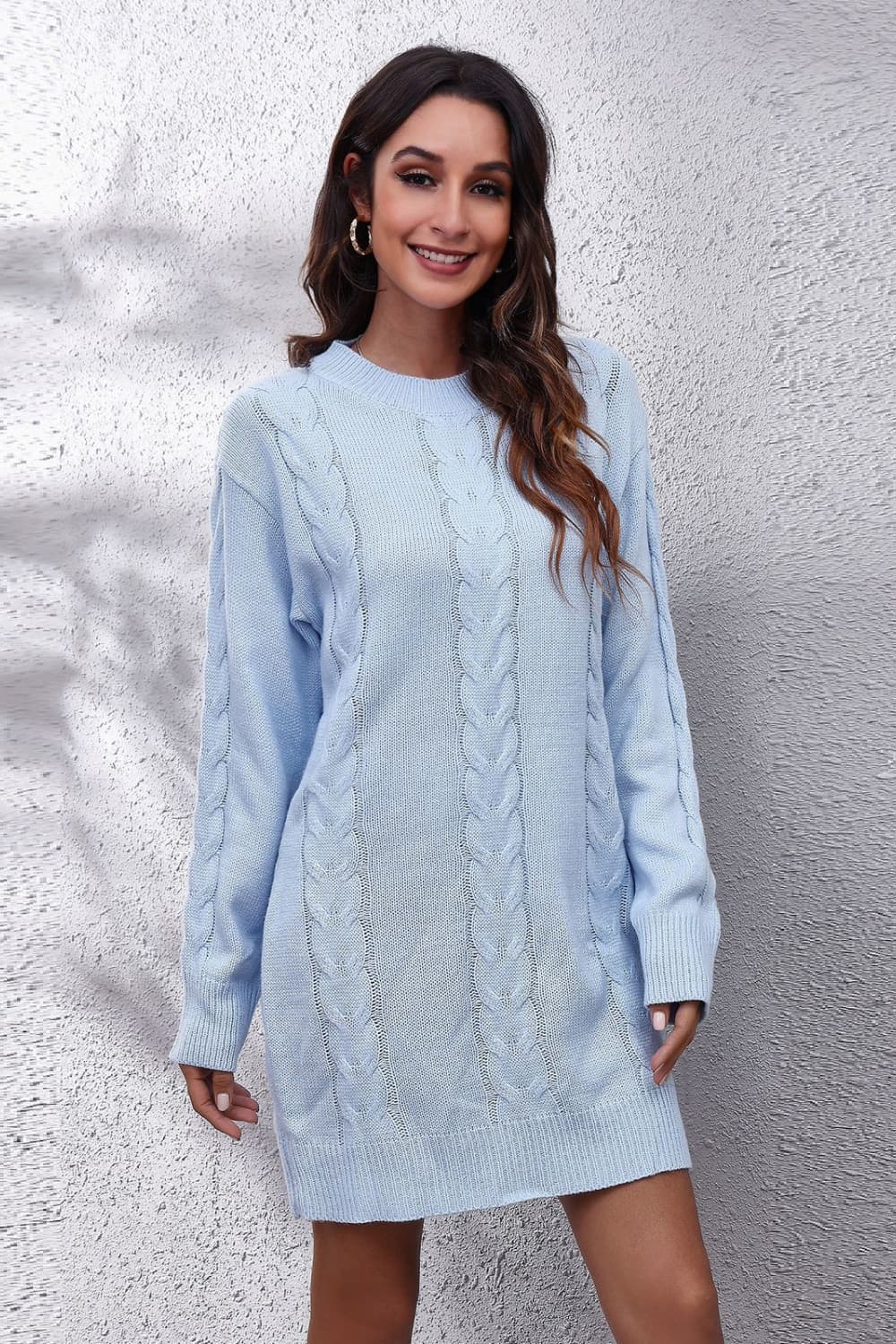 Light blue cable knit sweater dress with crew neck and long sleeves.