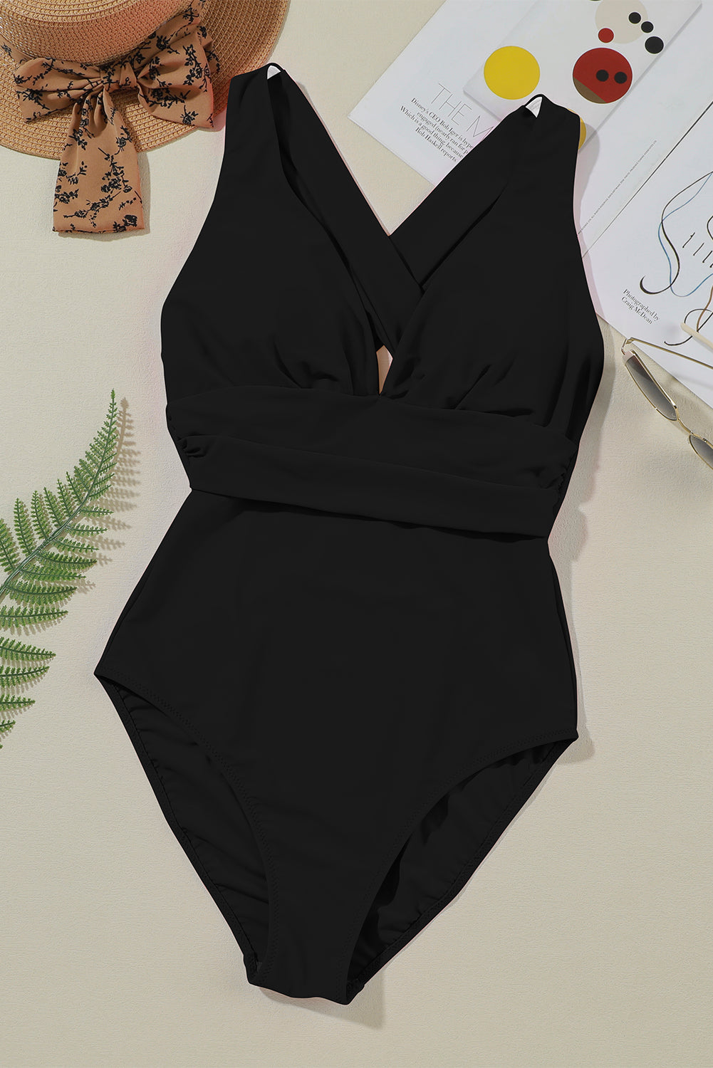 Black crisscross back plunge one-piece swimsuit with a ruched waistband.