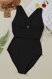 Black crisscross back plunge one-piece swimsuit with a ruched waistband.