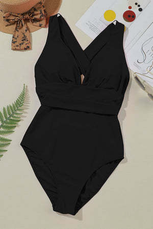 Black crisscross back plunge one-piece swimsuit with a ruched waistband.