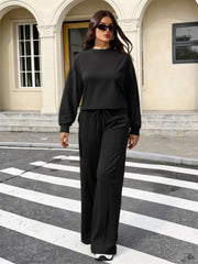 Black long sleeve relaxed top and wide leg pants set with drawstring waist.