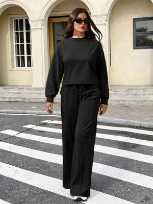 Black long sleeve relaxed top and wide leg pants set with drawstring waist.