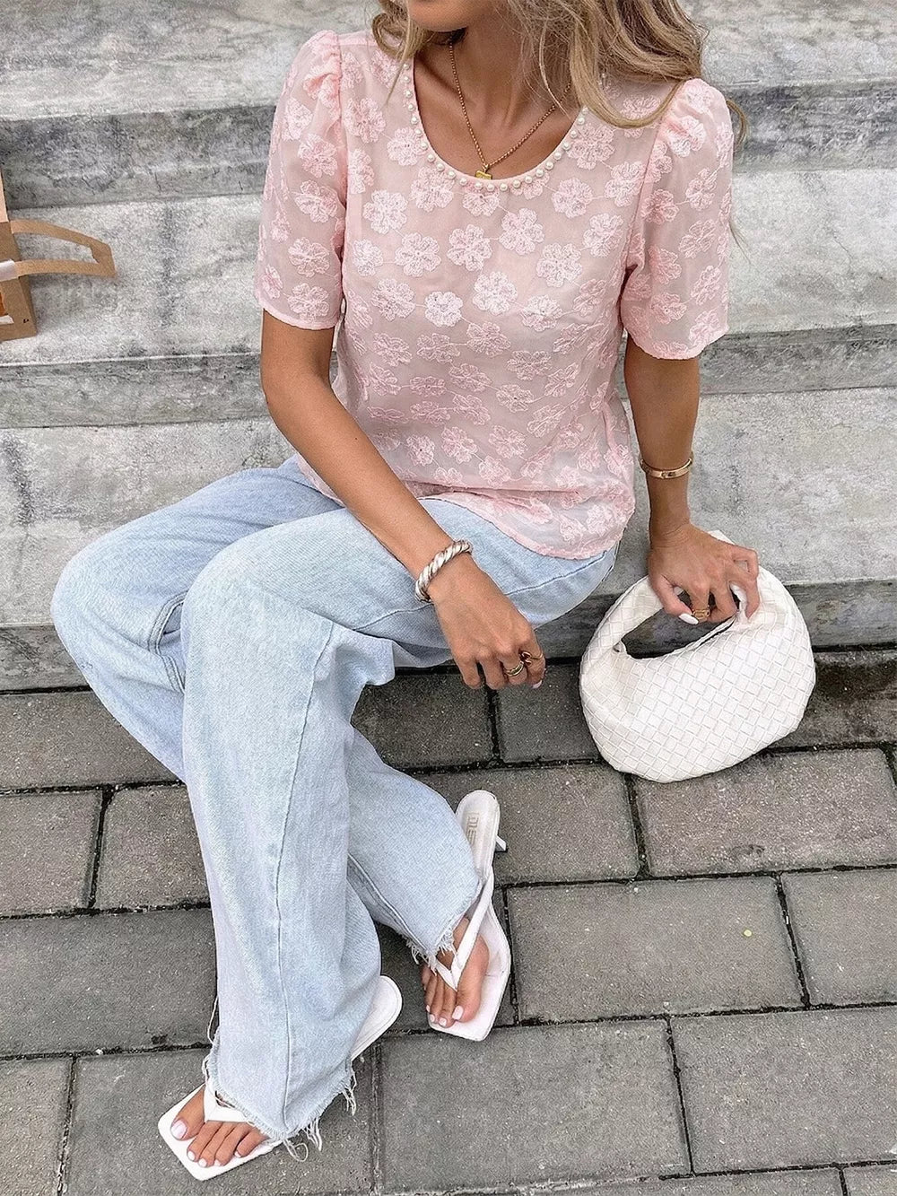 Pink embroidered floral blouse with pearl trim and puff sleeves.