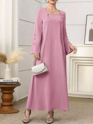 Elegant pink maxi dress with square neckline, long sleeves, and decorative buttons on sleeves and neckline.