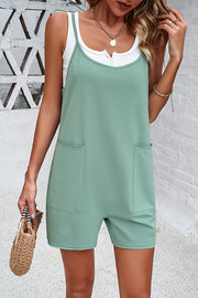 Light green relaxed romper with patch pockets and spaghetti straps, layered over a white henley shirt.