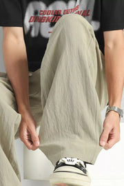 Lightweight wide-leg lounge sweatpants in Sage, showing relaxed fit and textured fabric.