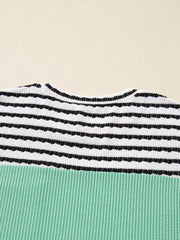 Turquoise and black striped ribbed long-sleeve top with a crew neck.