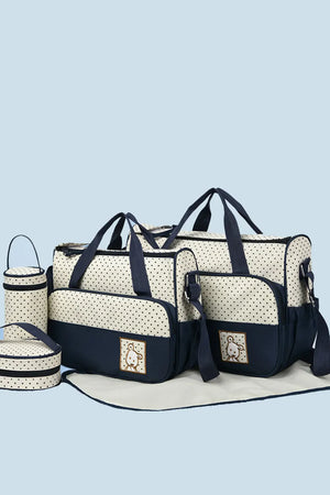 Polka dot diaper bag set in cream and dark navy with embroidered animal detail.