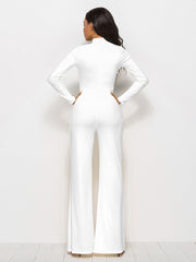 White high-waisted palazzo jumpsuit with long sleeves and a mock neck, shown from the back.