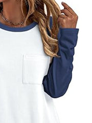 White long sleeve t-shirt with dark blue sleeves and neckline, featuring a chest pocket.