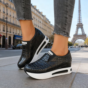 Black crocodile pattern slip-on flats with a chunky white platform sole.