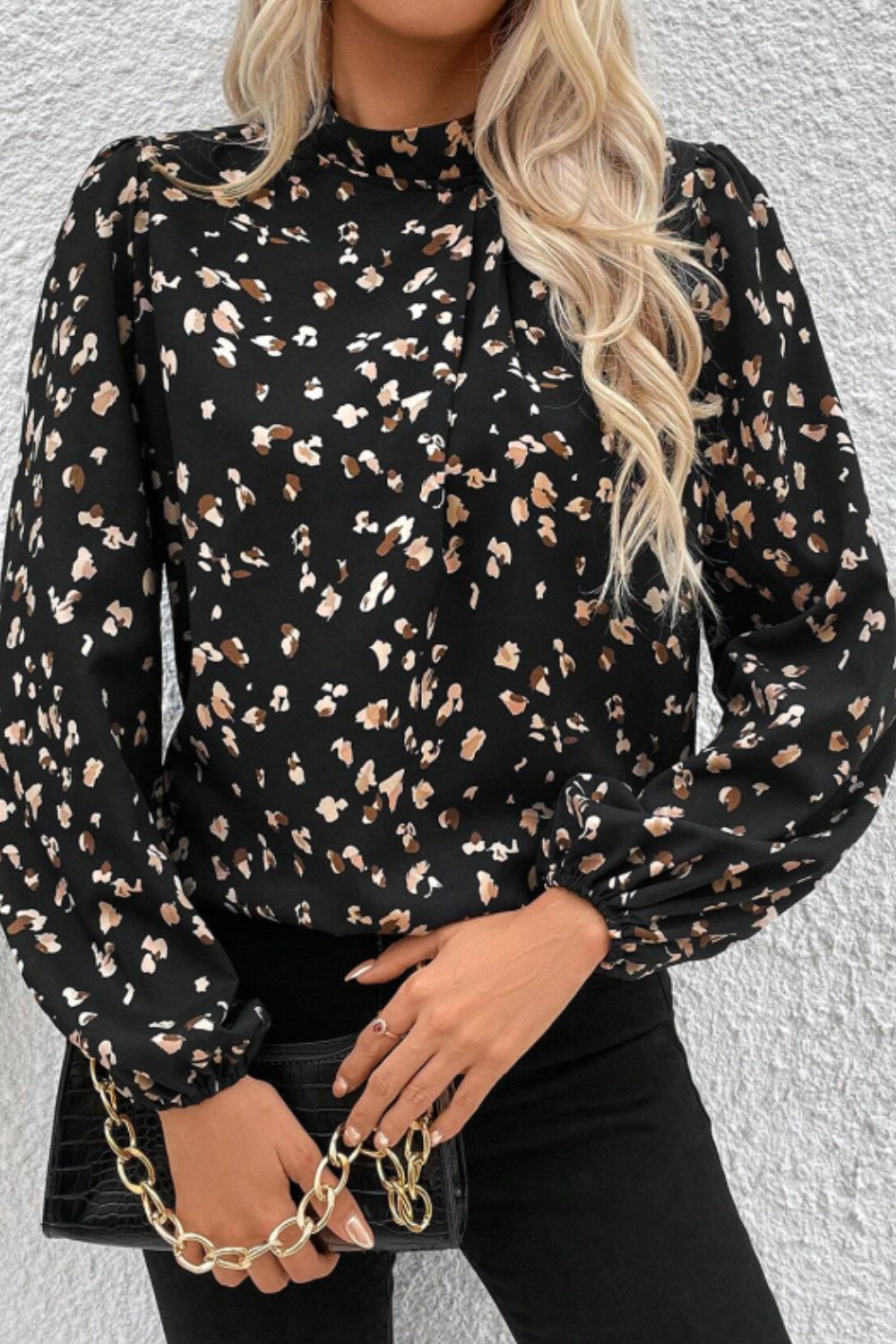 Black abstract print high-neck blouse with long puff sleeves.