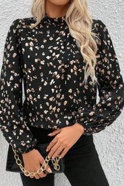 Black abstract print high-neck blouse with long puff sleeves.