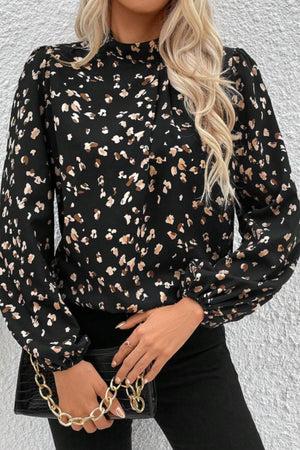 Black abstract print high-neck blouse with long puff sleeves.