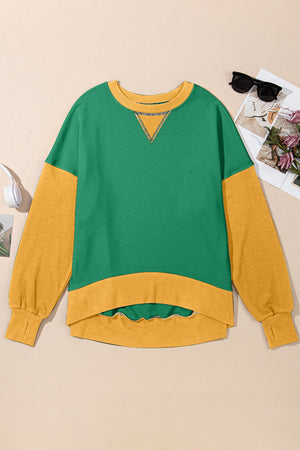 Green and yellow colorblock crewneck sweatshirt with contrast stitching and a hi-low hem