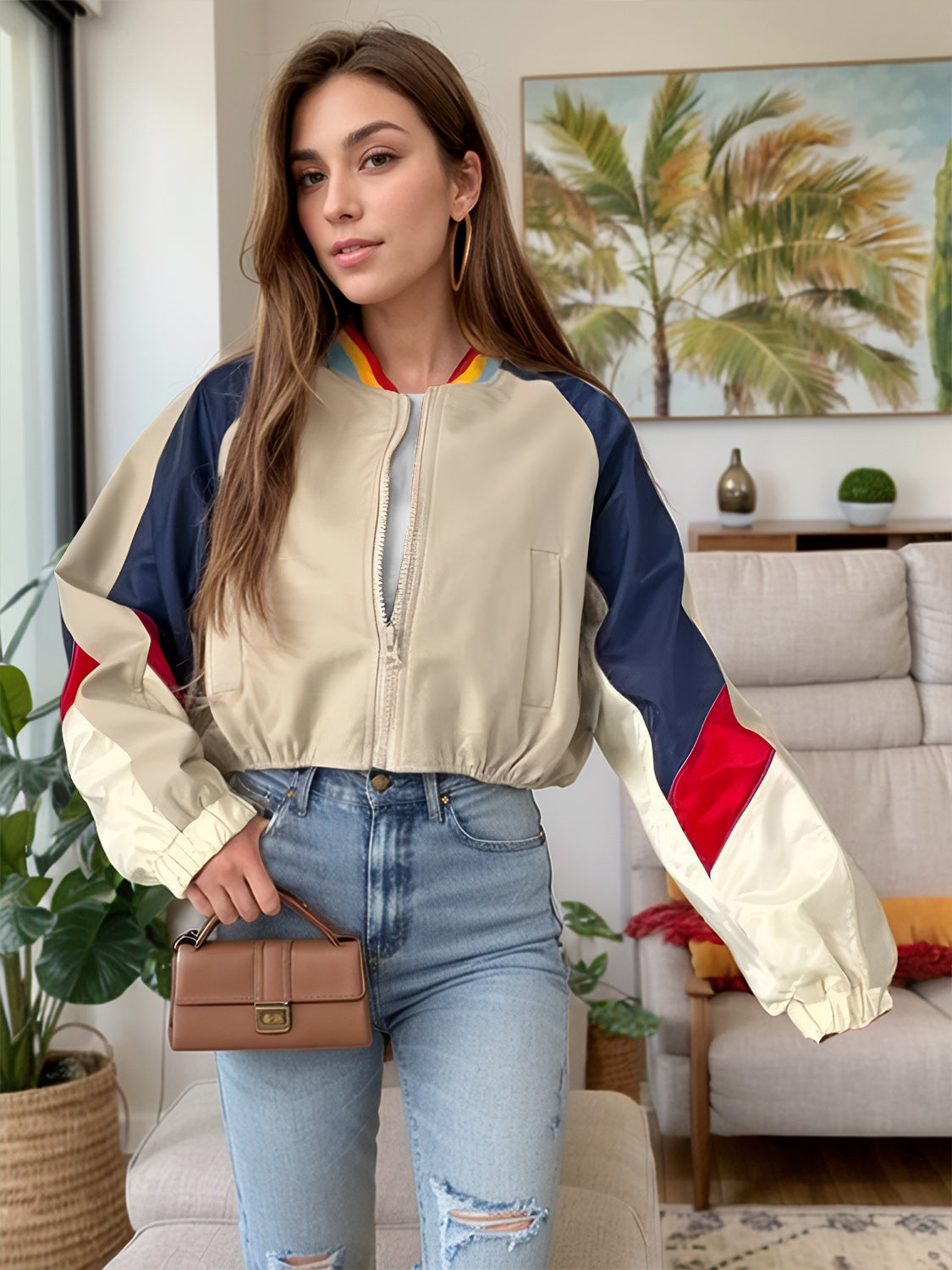 Colorblock cropped bomber jacket in beige with navy and red accents, featuring a zip front and elastic cuffs.