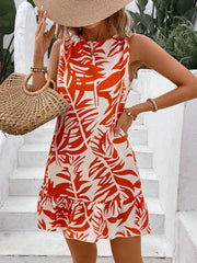 Tropical leaf print mini dress with ruffle hem and sleeveless design.