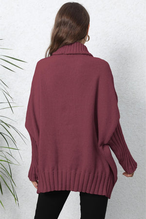 Burgundy knit turtleneck sweater with batwing sleeves and ribbed cuffs and hem.
