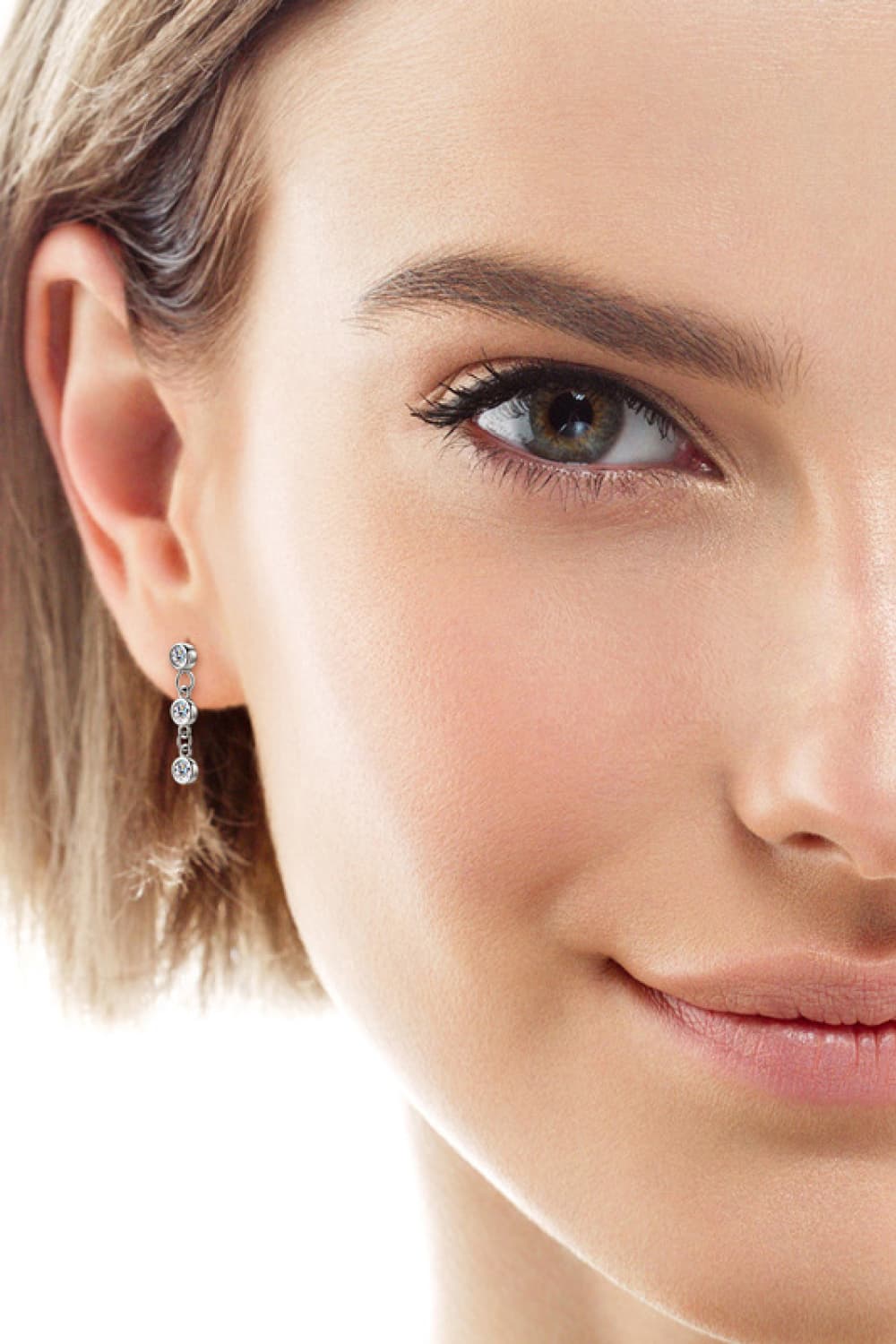 Silver triple stone cascade drop earrings with clear cubic zirconia.