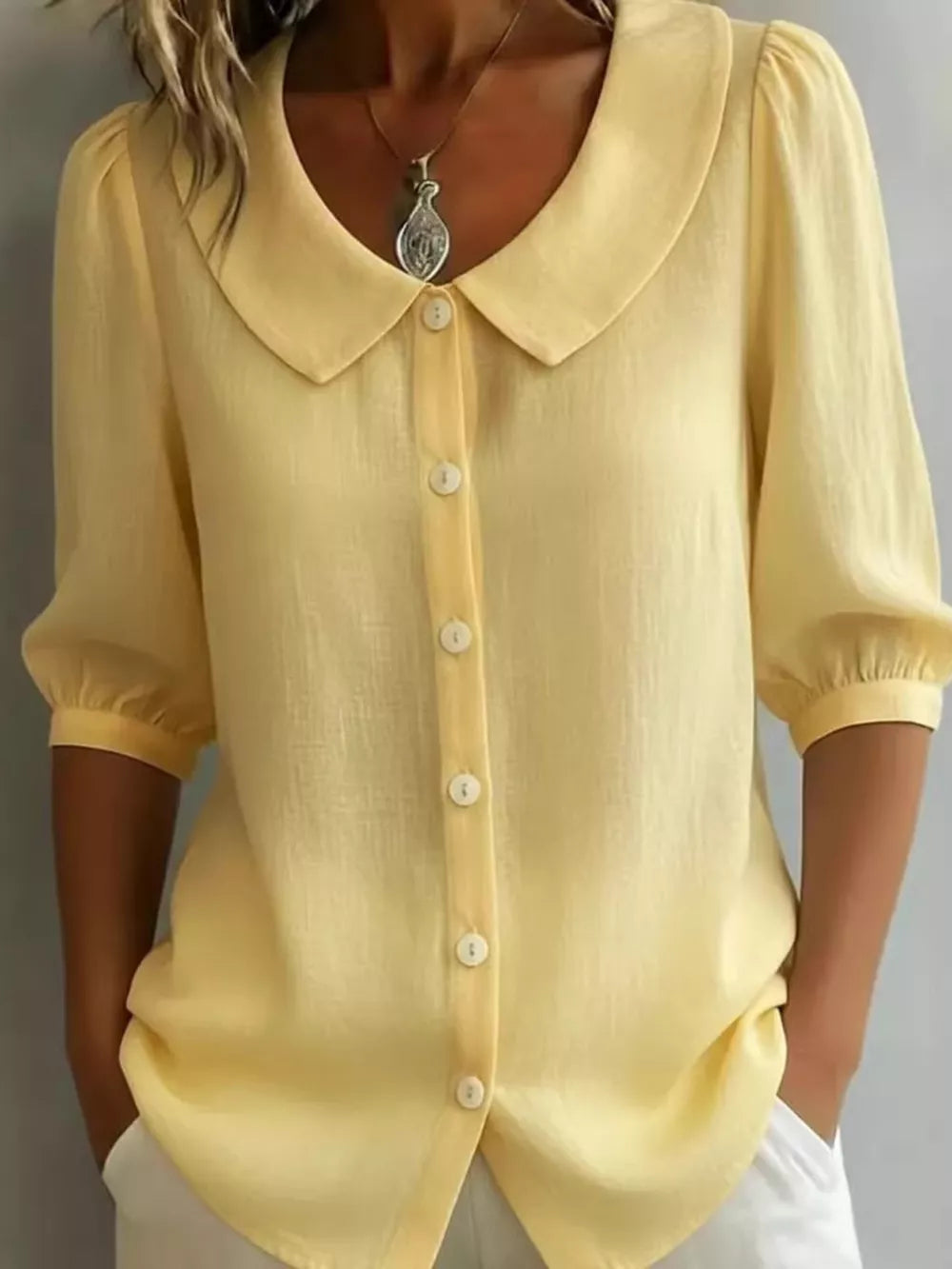 Yellow linen blend shirt with Peter Pan collar, puff sleeves, and button-down front.