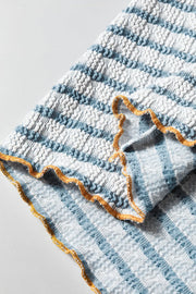 Textured stripe henley sweater in dusty blue with smocked fabric and lettuce edge trim.