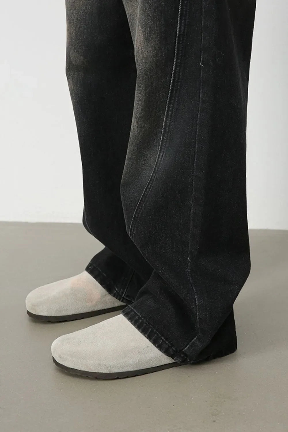 Faded wash wide leg denim jeans in dark, shown with a relaxed fit.