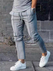 Light gray casual drawstring sweatpants with pockets and contrast panel detail.