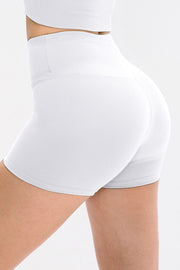 White ribbed sculpting active shorts with a high waist and v-cut detail.